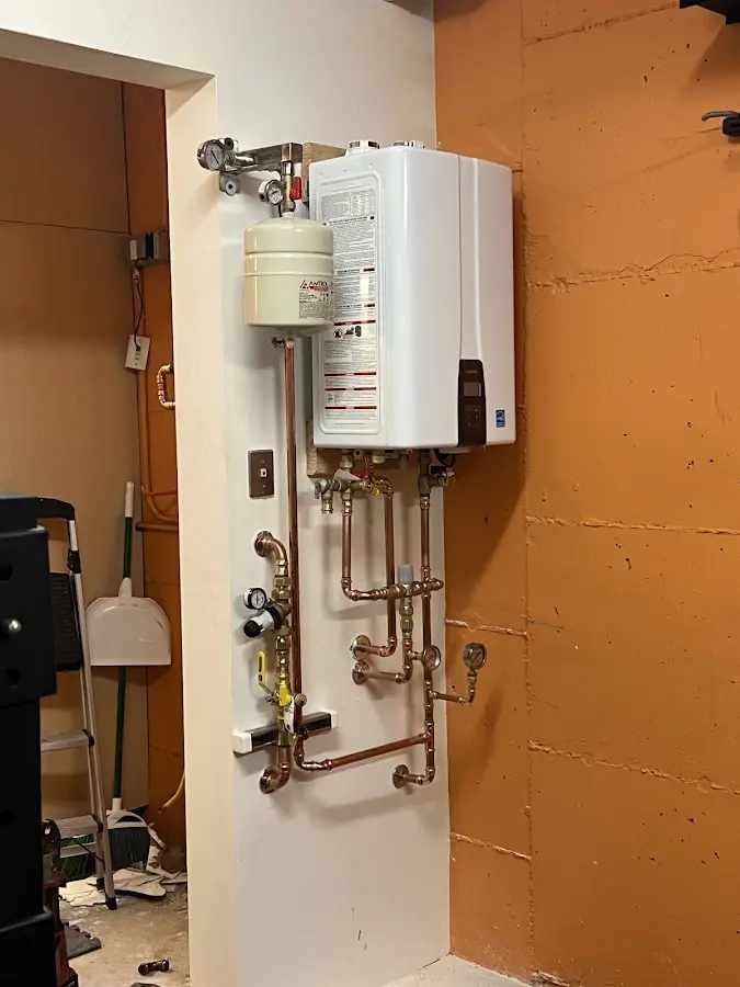 Plumbing technician inspecting water heater connections in Burr Ridge